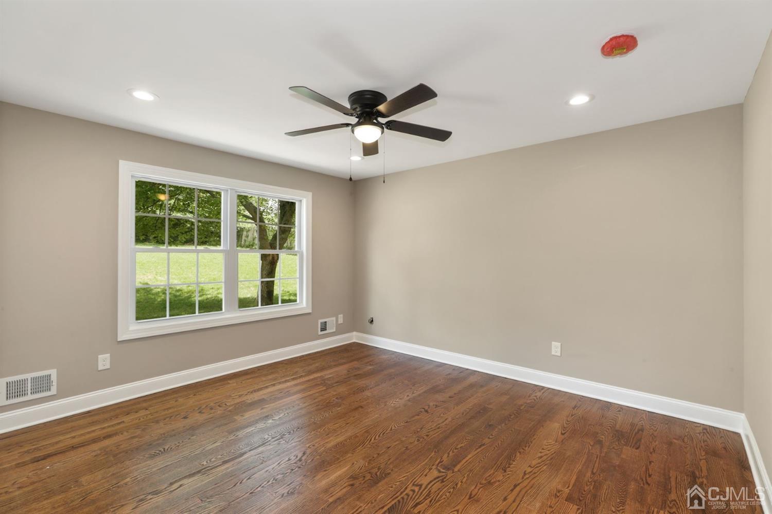 13 Perry Road East Brunswick, NJ 08816 - Photo 11 of 25 wooden floor in an empty room with a window