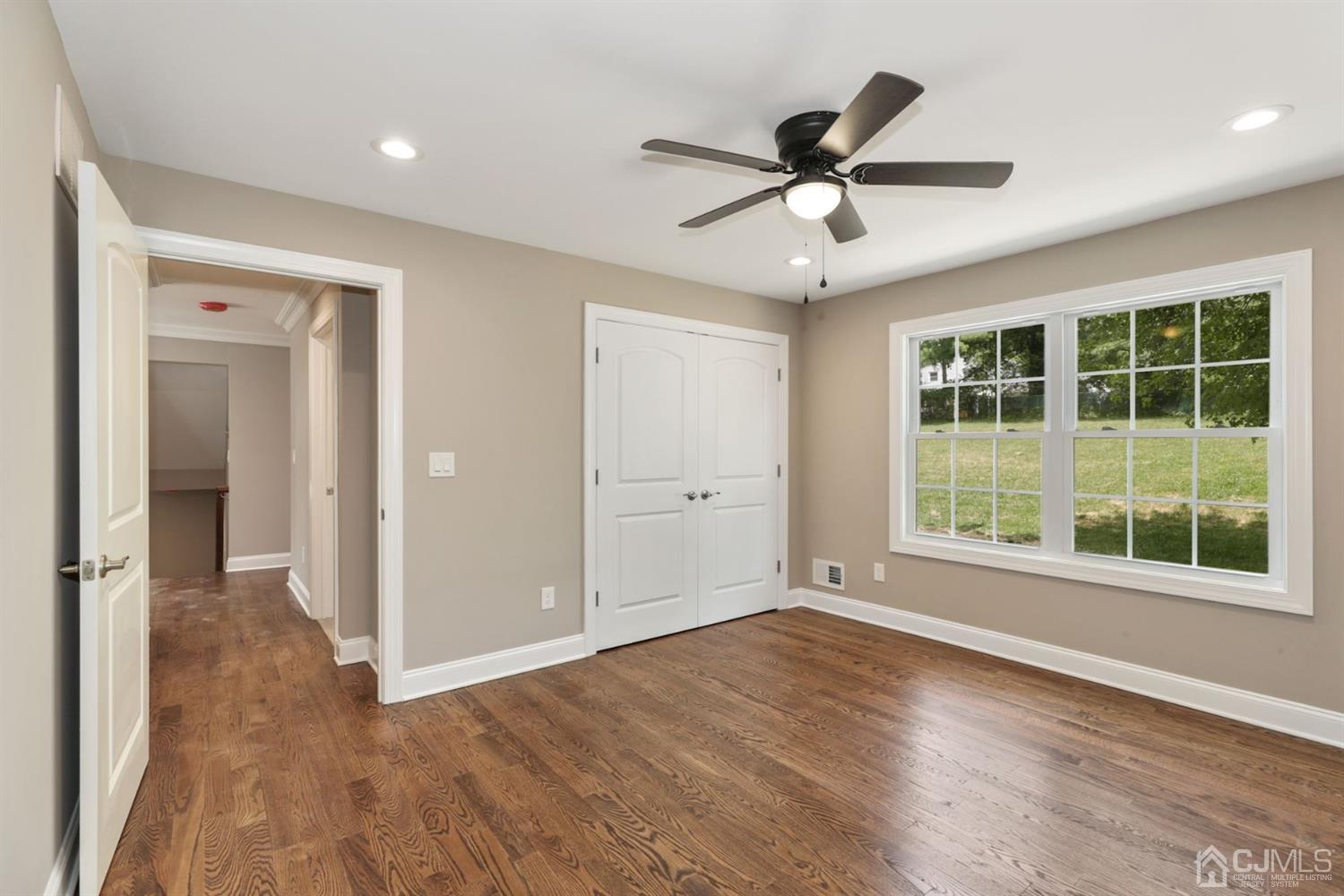 13 Perry Road East Brunswick, NJ 08816 - Photo 12 of 25 a view of an empty room with wooden floor and a window