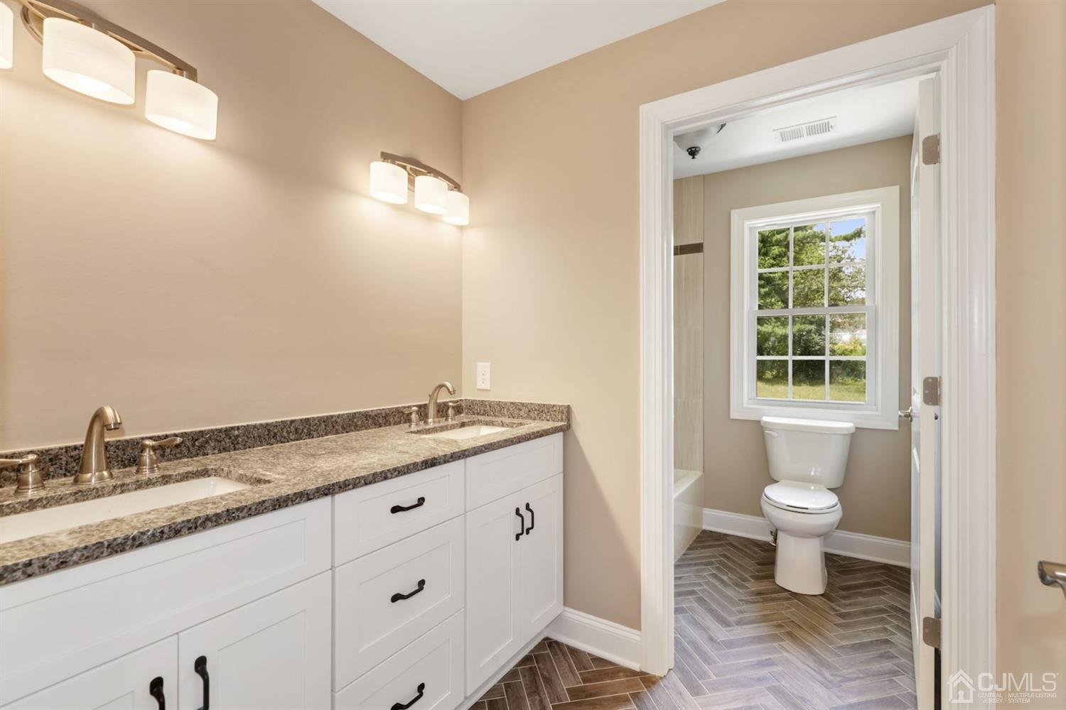 13 Perry Road East Brunswick, NJ 08816 - Photo 13 of 25 a bathroom with a granite countertop sink a toilet and a mirror