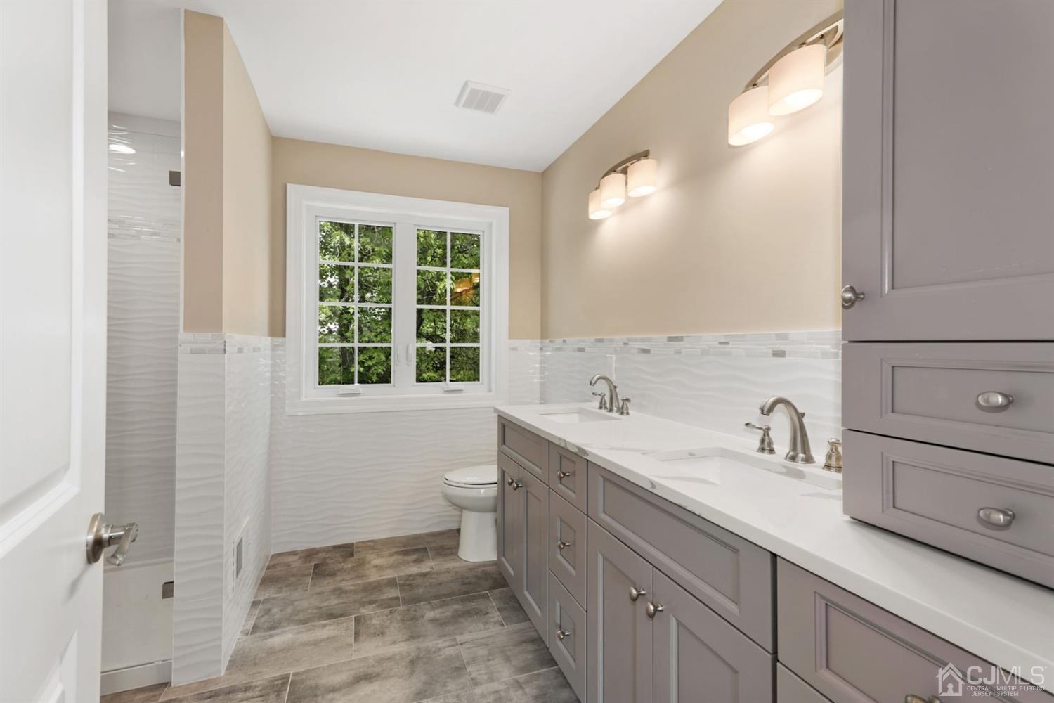 13 Perry Road East Brunswick, NJ 08816 - Photo 20 of 25 a bathroom with a sink a toilet and a window