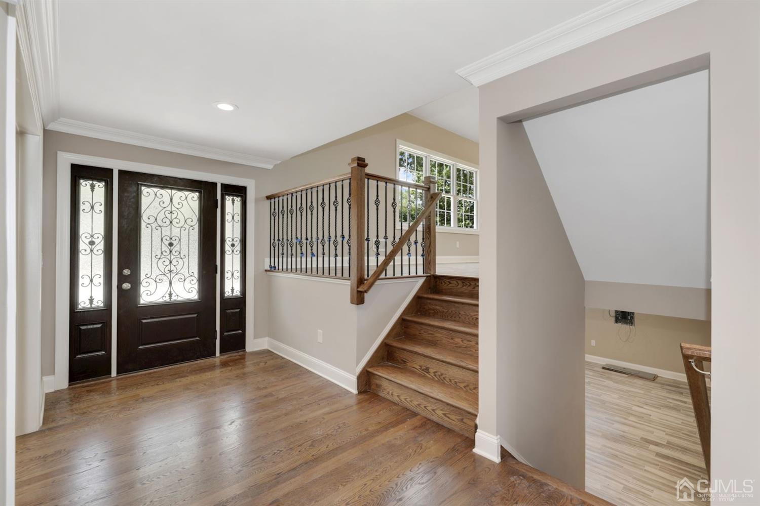 13 Perry Road East Brunswick, NJ 08816 - Photo 3 of 25 a view of an entryway with wooden floor and stairs