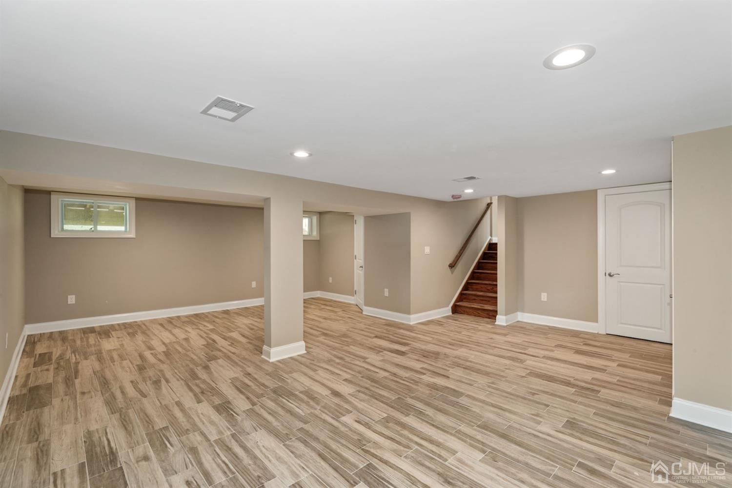 13 Perry Road East Brunswick, NJ 08816 - Photo 23 of 25 a view of an empty room with wooden floor and stairs