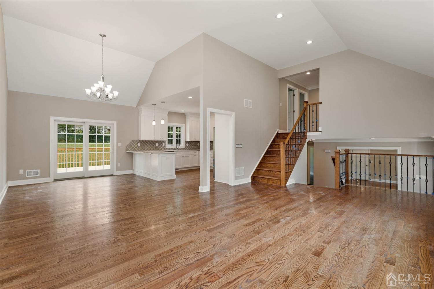 13 Perry Road East Brunswick, NJ 08816 - Photo 6 of 25 a view of an empty room with wooden floor and a window