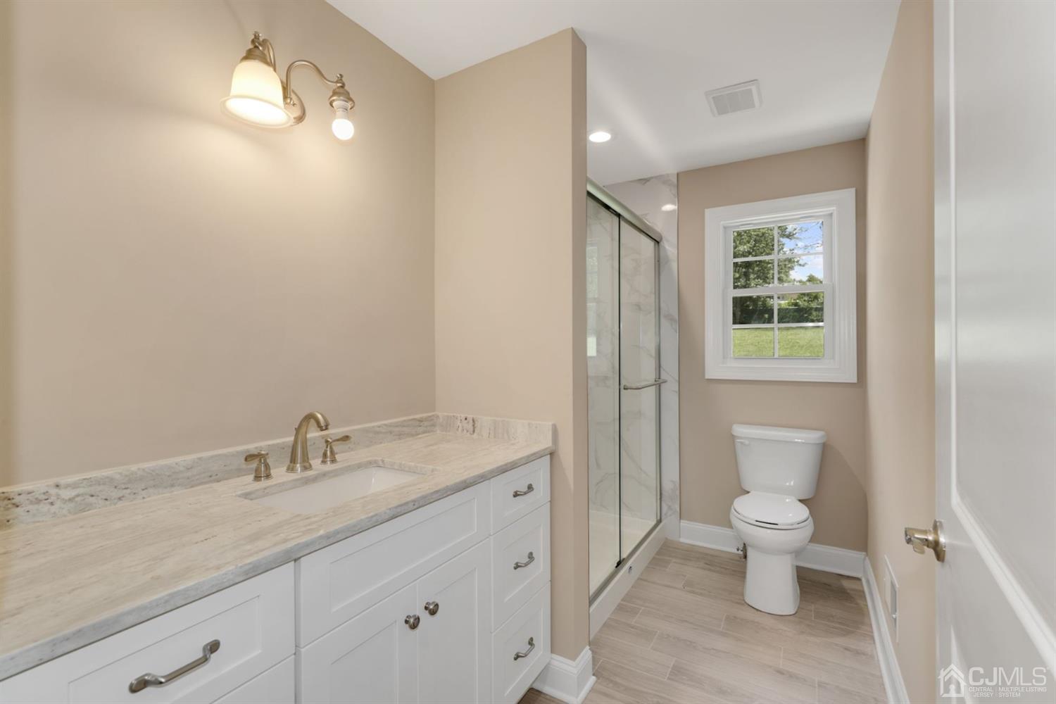 13 Perry Road East Brunswick, NJ 08816 - Photo 9 of 25 a spacious bathroom with a granite countertop sink a toilet and a mirror