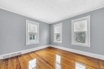 71 Knox Street, Unit 2 Springfield, MA 01105 - Photo 6 of 14 a view of an empty room with a window and wooden floor