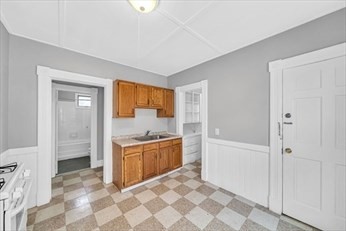 71 Knox Street, Unit 2 Springfield, MA 01105 - Photo 8 of 14 a view of a kitchen with a sink and dishwasher cabinets