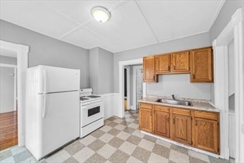 71 Knox Street, Unit 2 Springfield, MA 01105 - Photo 9 of 14 a kitchen with a sink a refrigerator a window and cabinets