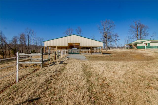 4881 Campbell Road Cross Plains, TN 37049 - Photo 14 of 19 a view of a yard with table and chairs under an umbrella