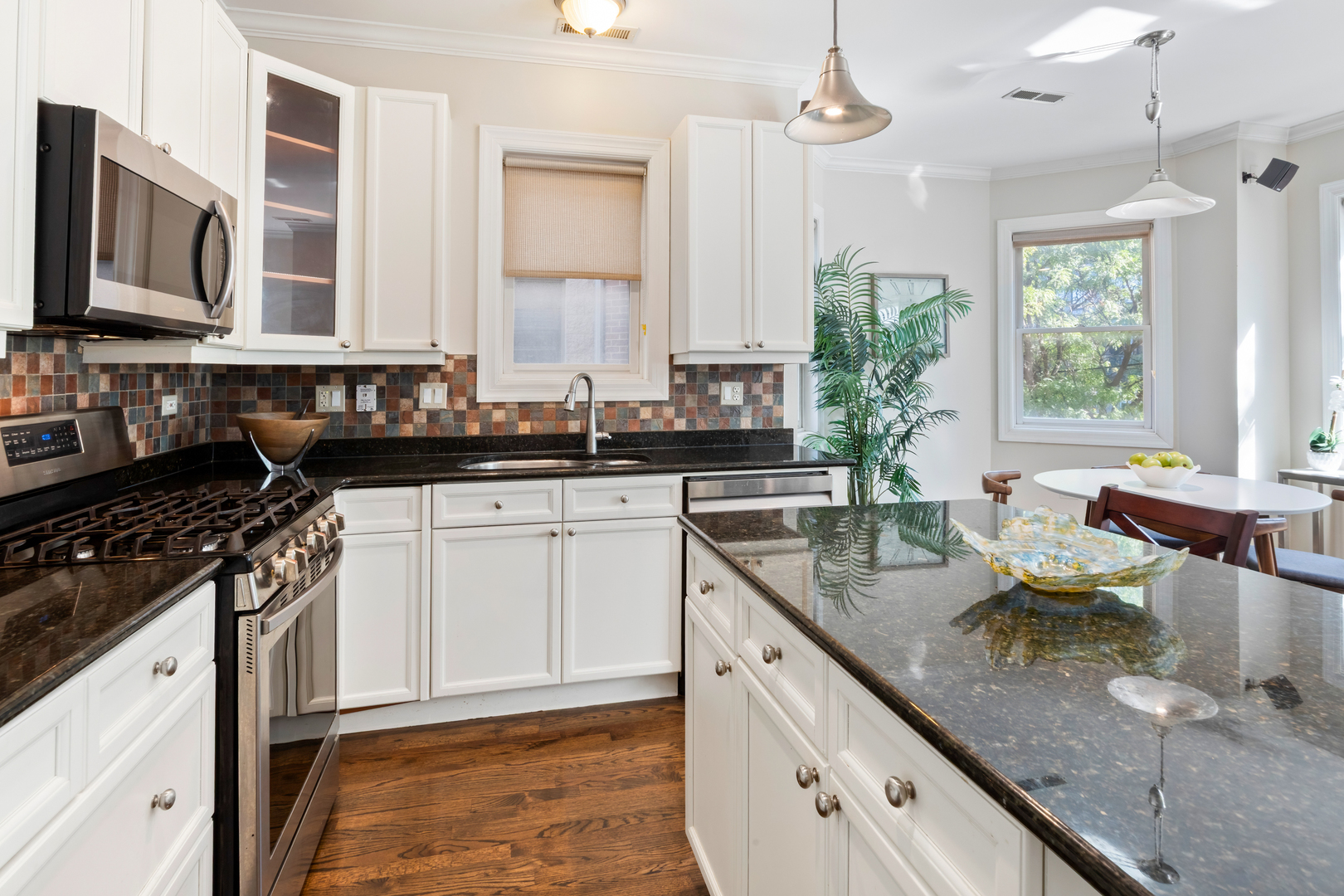 3438 North Ashland Avenue, Unit 2N Chicago, IL 60657 - Photo 12 of 22 a kitchen with stainless steel appliances granite countertop a sink stove and cabinets