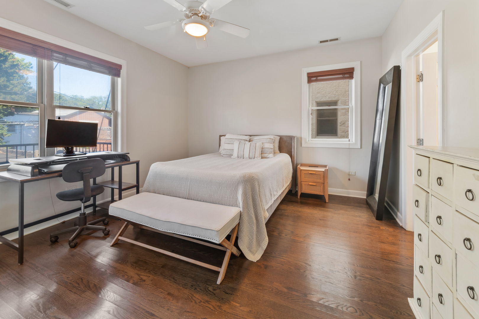 3438 North Ashland Avenue, Unit 2N Chicago, IL 60657 - Photo 16 of 22 a bedroom with a bed and a flat tv screen on the dresser
