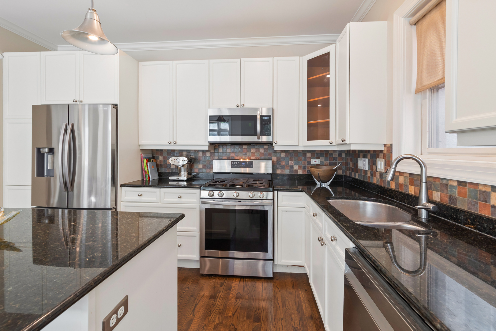 3438 North Ashland Avenue, Unit 2N Chicago, IL 60657 - Photo 10 of 22 a kitchen with stainless steel appliances granite countertop a sink stove and refrigerator