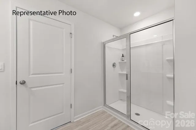 a bathroom with a glass shower door