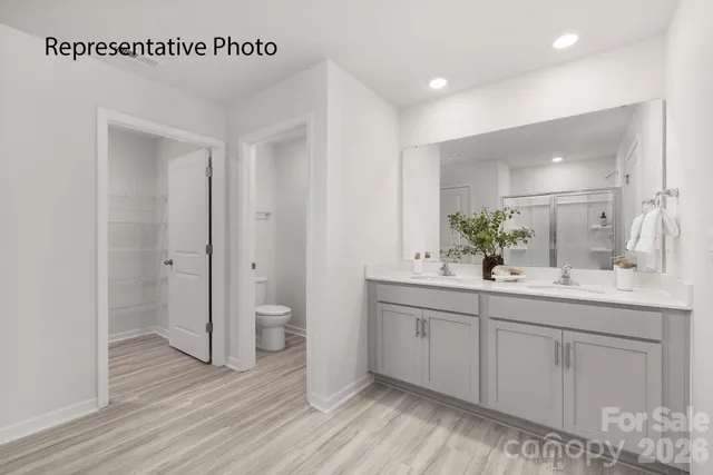 a spacious bathroom with a double vanity sink and a mirror