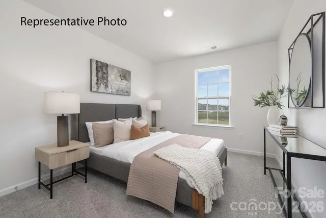 a bedroom with a bed and a lamp