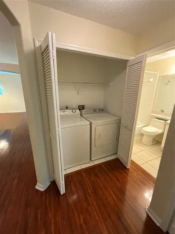 a room with wooden floor and utility room