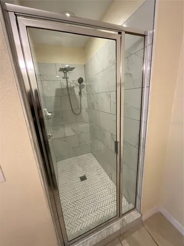 a bathroom with a glass shower door