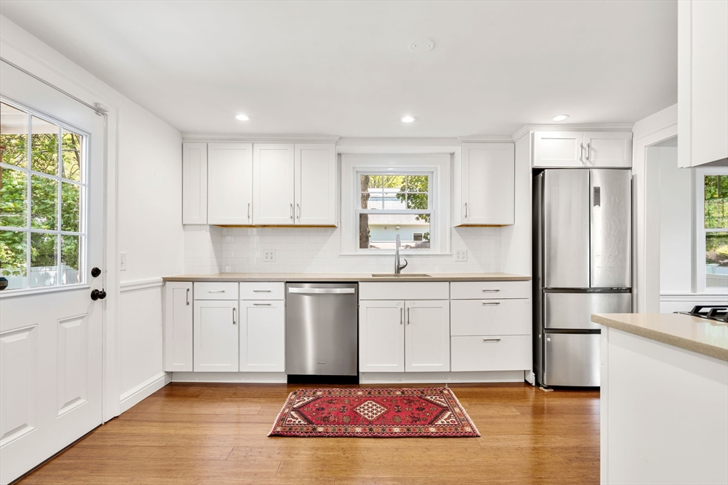 14 Pierrepont Road Newton, MA 02462 - Photo 9 of 33 a kitchen with white cabinets sink and refrigerator