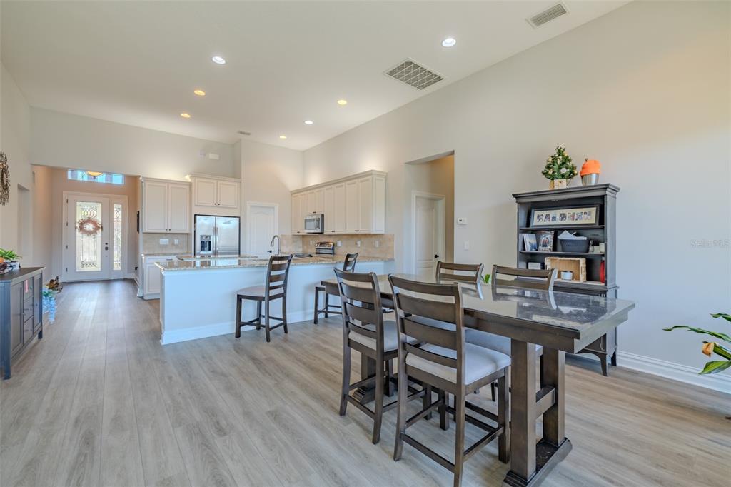 4950 Diamonds Palm Loop Wesley Chapel, FL 33543 - Photo 13 of 65 a view of a dining room with furniture and wooden floor