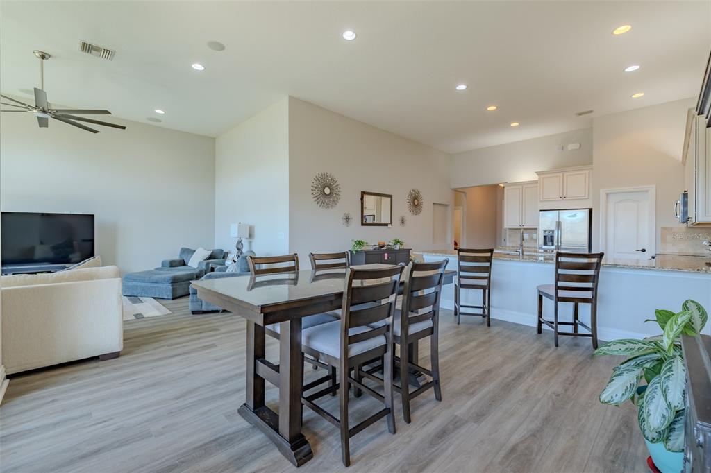 4950 Diamonds Palm Loop Wesley Chapel, FL 33543 - Photo 15 of 65 a view of a dining room with furniture and wooden floor