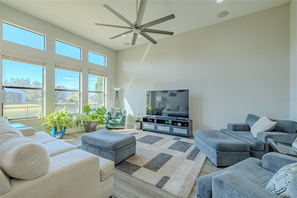 4950 Diamonds Palm Loop Wesley Chapel, FL 33543 - Photo 16 of 65 a living room with furniture and a large window