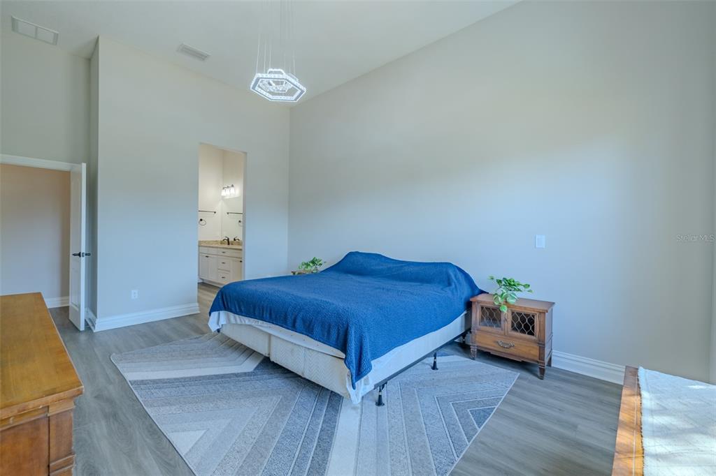 4950 Diamonds Palm Loop Wesley Chapel, FL 33543 - Photo 20 of 65 a bedroom with a bed and a dresser