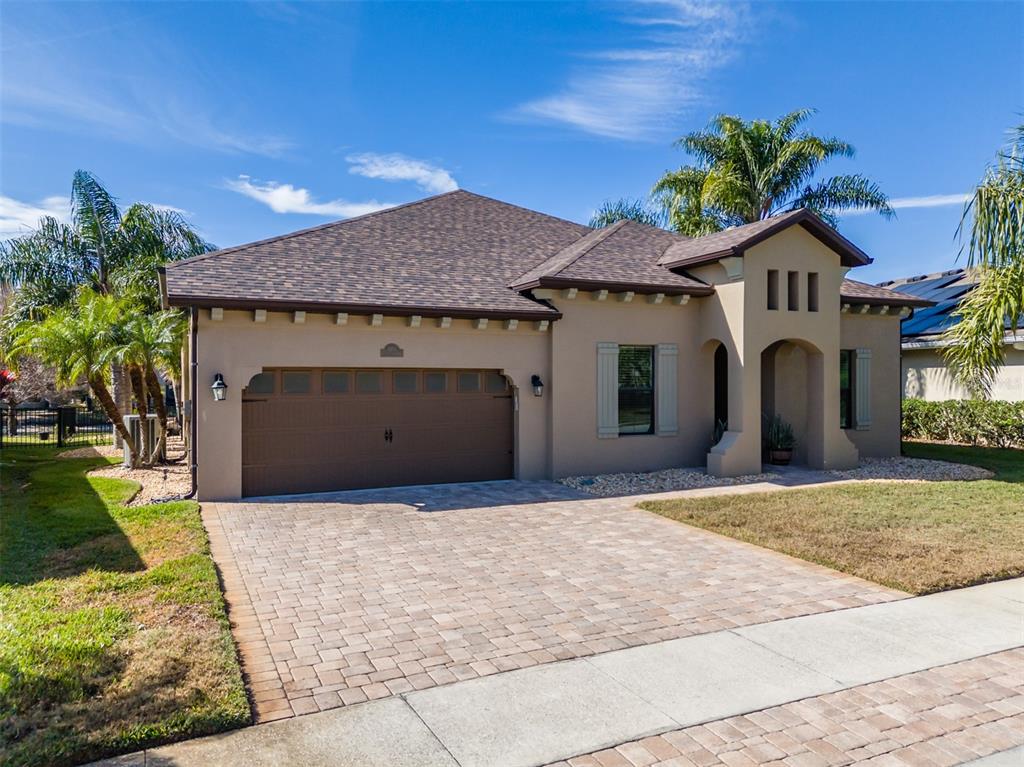 4950 Diamonds Palm Loop Wesley Chapel, FL 33543 - Photo 2 of 65 a front view of a house with a yard and garage