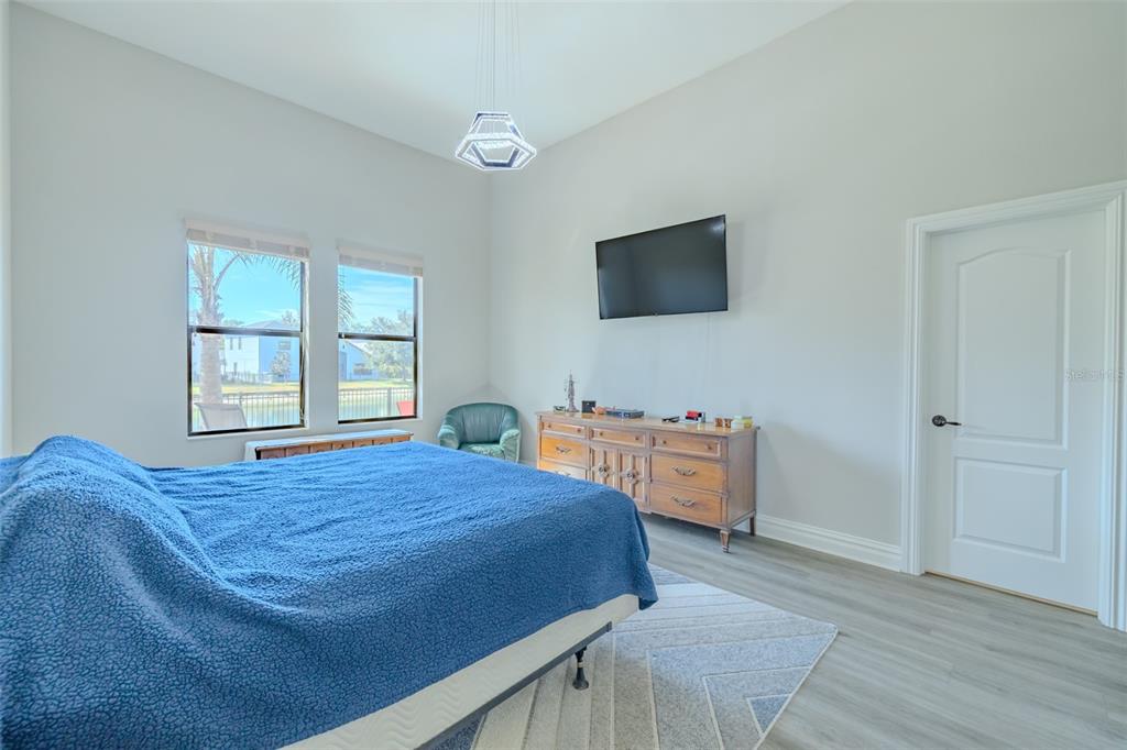 4950 Diamonds Palm Loop Wesley Chapel, FL 33543 - Photo 21 of 65 a bedroom with a bed and a flat screen tv