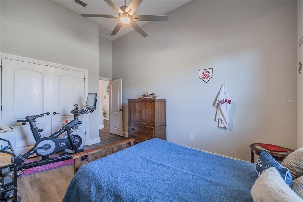 4950 Diamonds Palm Loop Wesley Chapel, FL 33543 - Photo 25 of 65 a bedroom with bed and wooden floor