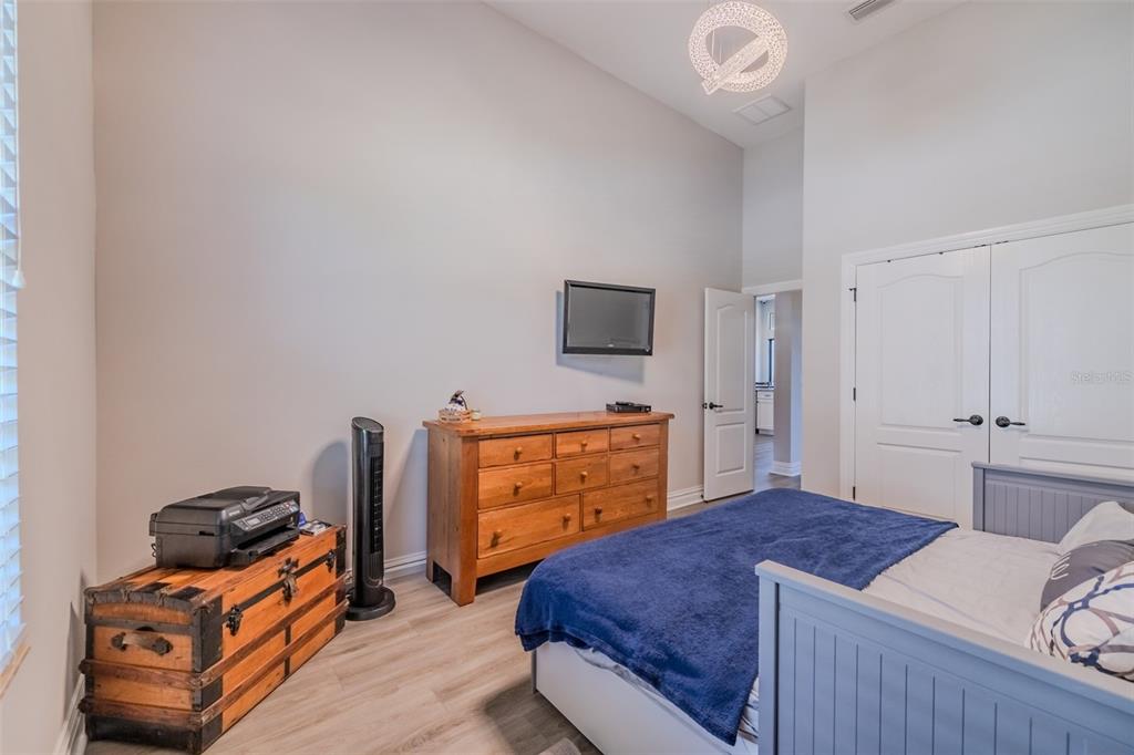 4950 Diamonds Palm Loop Wesley Chapel, FL 33543 - Photo 26 of 65 a bedroom with a bed and a flat tv screen on the dresser