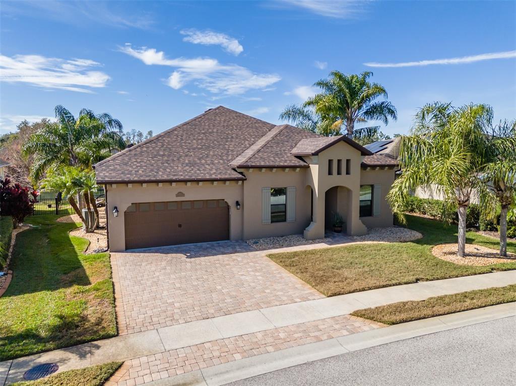 4950 Diamonds Palm Loop Wesley Chapel, FL 33543 - Photo 3 of 65 a front view of a house with a yard and garage