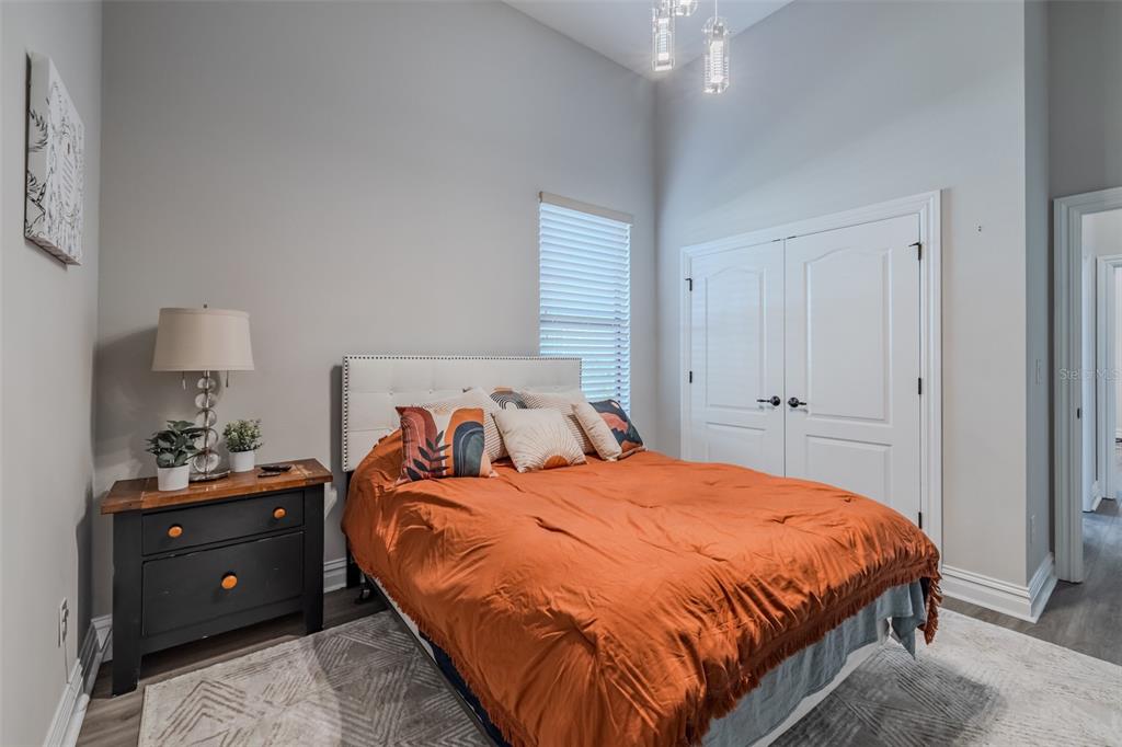 4950 Diamonds Palm Loop Wesley Chapel, FL 33543 - Photo 31 of 65 a bedroom with a bed and a lamp on dresser