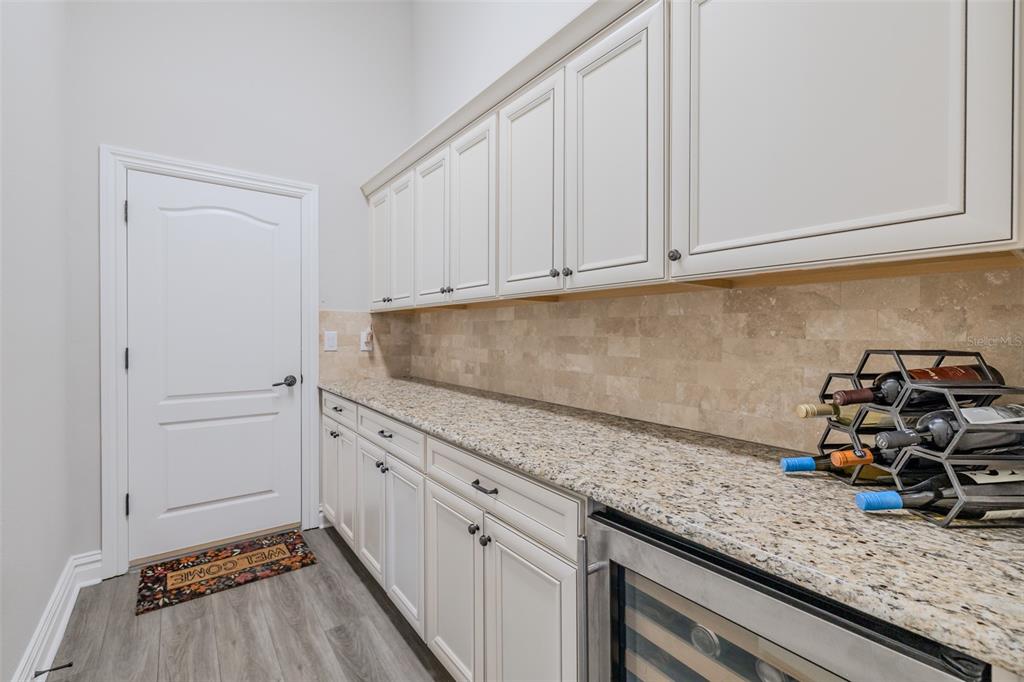 4950 Diamonds Palm Loop Wesley Chapel, FL 33543 - Photo 32 of 65 a kitchen with granite countertop white cabinets and sink