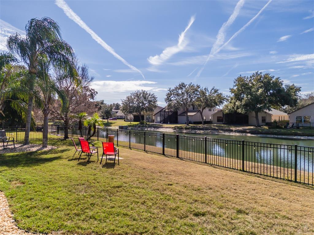 4950 Diamonds Palm Loop Wesley Chapel, FL 33543 - Photo 38 of 65 a view of a lake with a houses