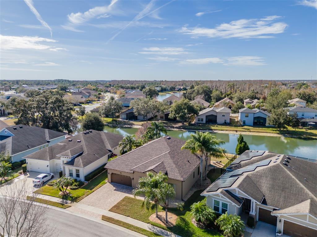 4950 Diamonds Palm Loop Wesley Chapel, FL 33543 - Photo 39 of 65 an aerial view of residential houses with outdoor space and lake view