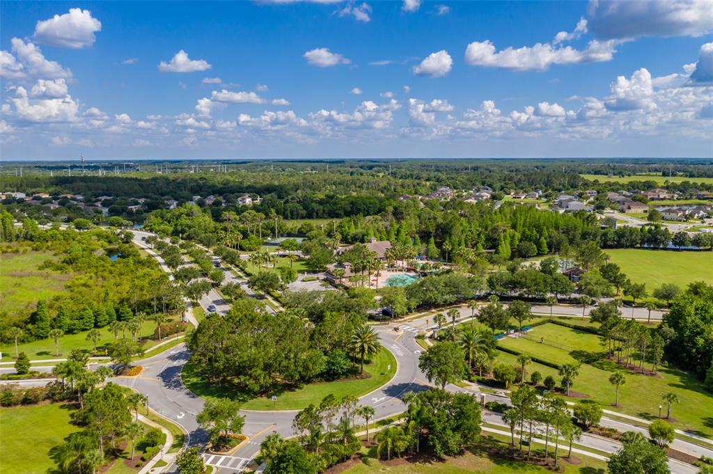 4950 Diamonds Palm Loop Wesley Chapel, FL 33543 - Photo 57 of 65 a view of a city with lots of residential buildings and mountain in the background