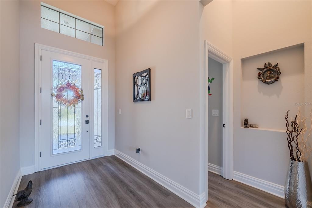 4950 Diamonds Palm Loop Wesley Chapel, FL 33543 - Photo 6 of 65 an empty room with wooden floor and hallway