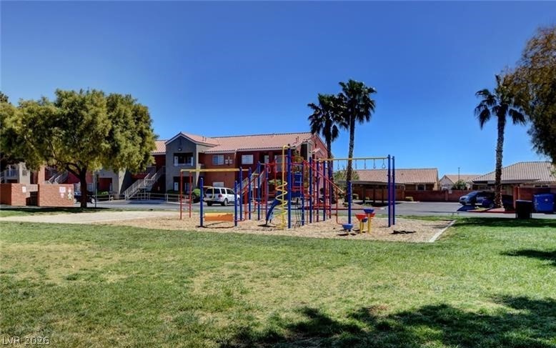 4730 East Craig Road, Unit 2102 Las Vegas, NV 89115 - Photo 11 of 13 A vibrant playground beckons, set against a backdrop of community residences under a clear sky.