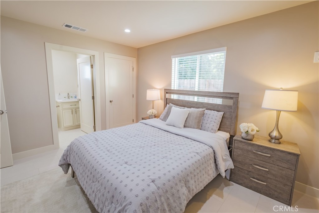 223 South Aprilia Avenue Compton, CA 90220 - Photo 38 of 46 a bedroom with a bed and a window