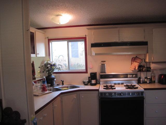 939 South Valley View Road, Unit 6 Ashland, OR 97520 - Photo 8 of 14 a kitchen with stainless steel appliances a sink stove and cabinets