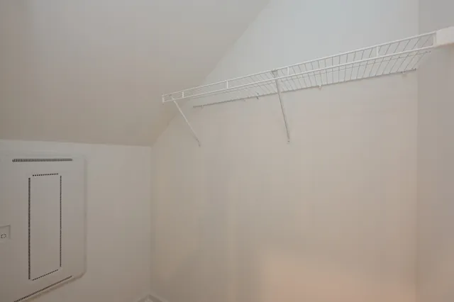 a kitchen with stainless steel appliances a refrigerator oven a sink dishwasher and white cabinets with wooden floor