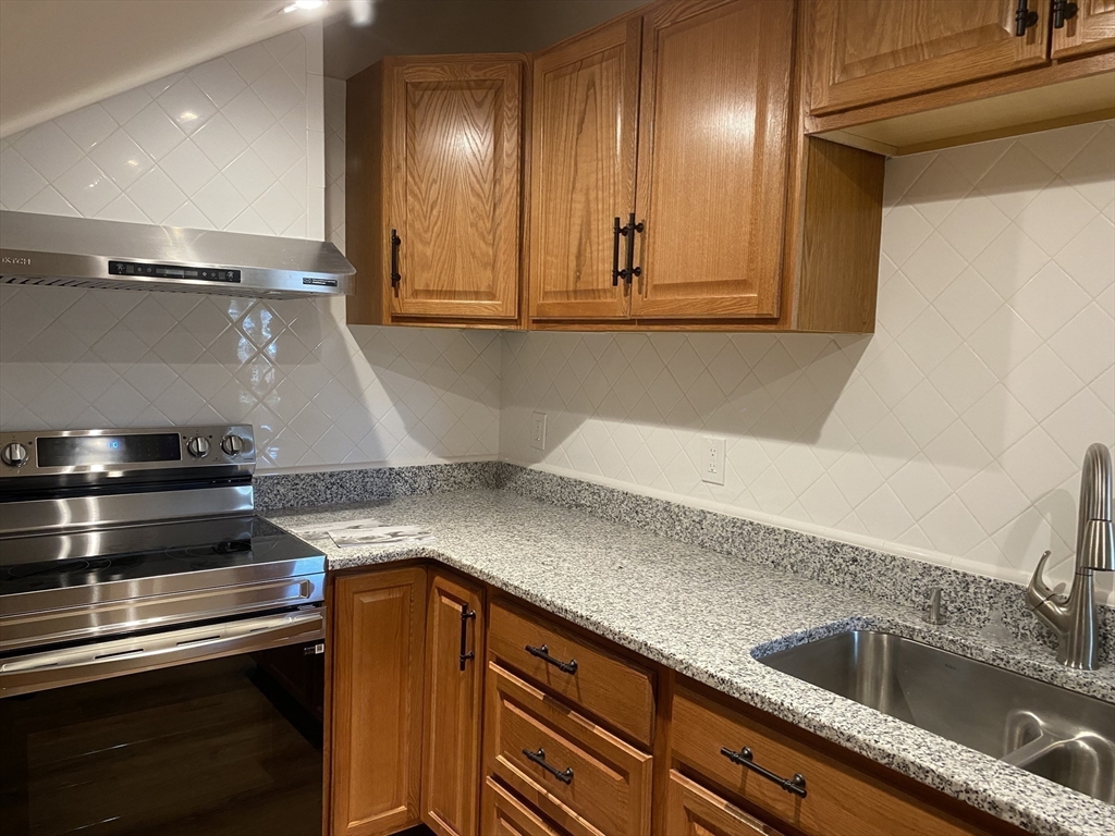 374 Main Street, Unit 2 Gloucester, MA 01930 - Photo 4 of 12 a kitchen with a sink and cabinets