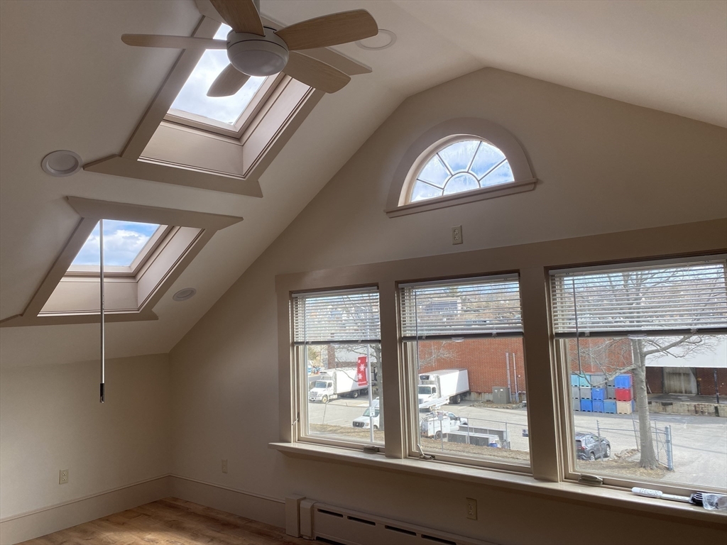 374 Main Street, Unit 2 Gloucester, MA 01930 - Photo 6 of 12 an empty room with wooden floor and windows