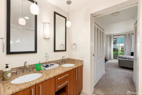 a bathroom with a granite countertop sink mirror and a bathtub