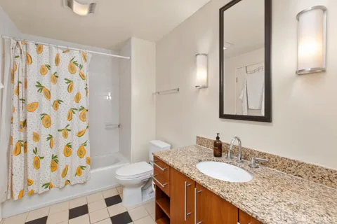 a bathroom with a granite countertop sink and a mirror