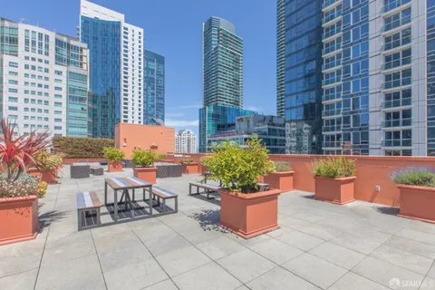 a building outdoor space with patio furniture and potted plants