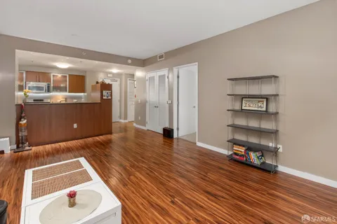 a living room with hard wood floors and a wooden floor