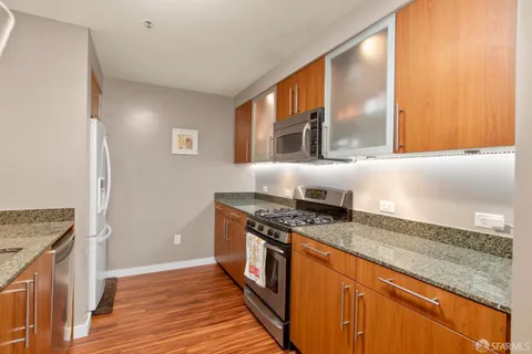 a kitchen with stainless steel appliances granite countertop a stove and a sink