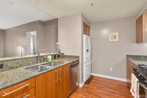 a bathroom with a granite countertop double vanity sink and mirror