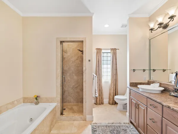 a bathroom with double vanity sinks a vanity a lamp and a mirror