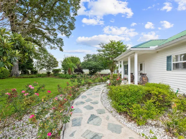 a front view of a house with garden